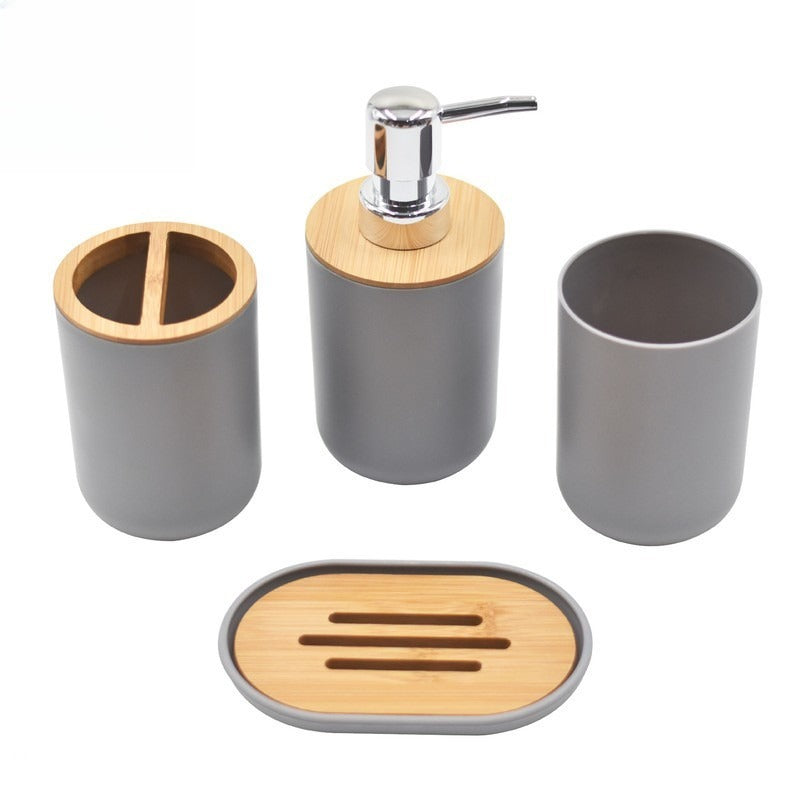 Pilkos spalvos vonios reikmenų rinkinys su bambuko detalėmis, apvalios formos.